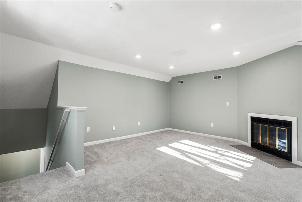 9 Oak Ridge Drive, Unit 6 Maynard, MA 01754 - Photo 28 of 39 a view of an empty room with a fireplace