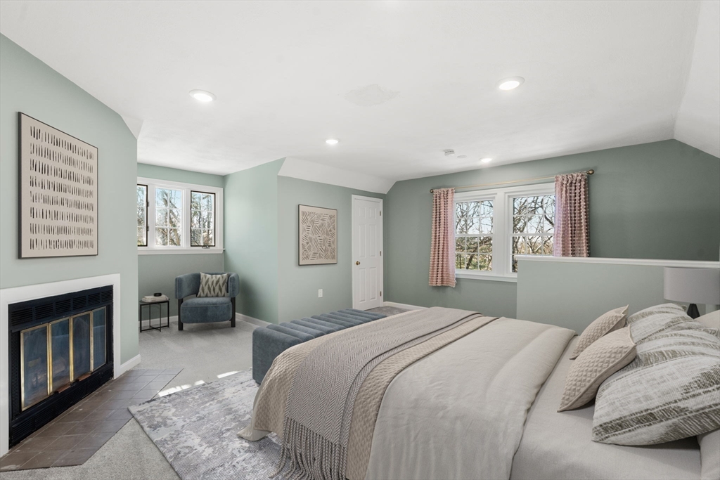 9 Oak Ridge Drive, Unit 6 Maynard, MA 01754 - Photo 5 of 39 a bedroom with a large bed a chandelier and a window