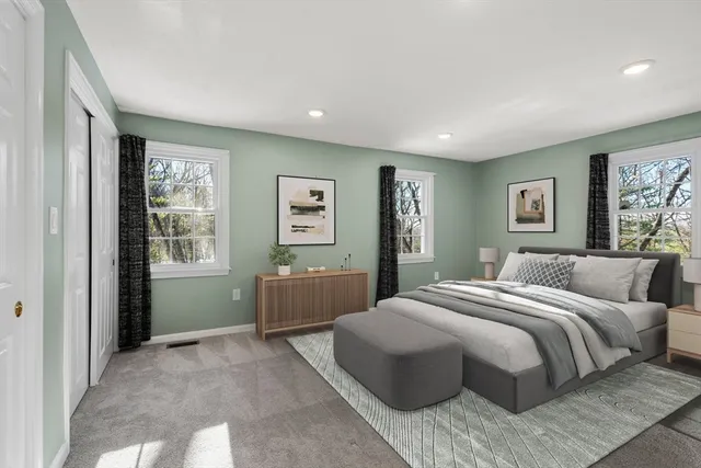 a bedroom with a large bed and a window