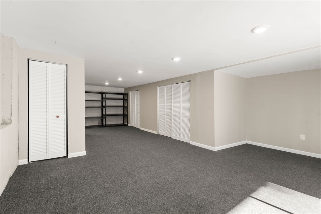 9 Oak Ridge Drive, Unit 6 Maynard, MA 01754 - Photo 8 of 39 a view of an empty room with a kitchen