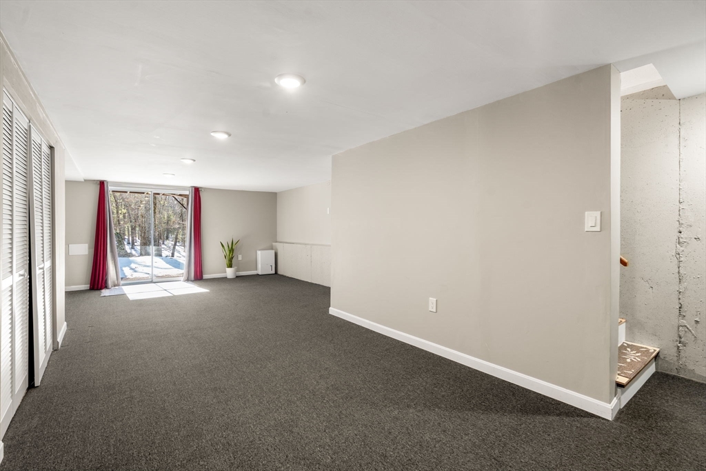 9 Oak Ridge Drive, Unit 6 Maynard, MA 01754 - Photo 9 of 39 a view of a livingroom with a staircase
