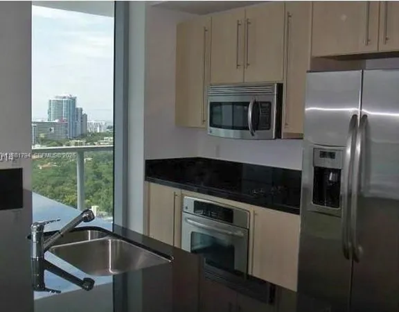 a kitchen that has a refrigerator and a sink