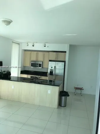 a kitchen with stainless steel appliances a sink and a counter