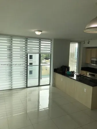 a view of a kitchen with a sink and cabinets