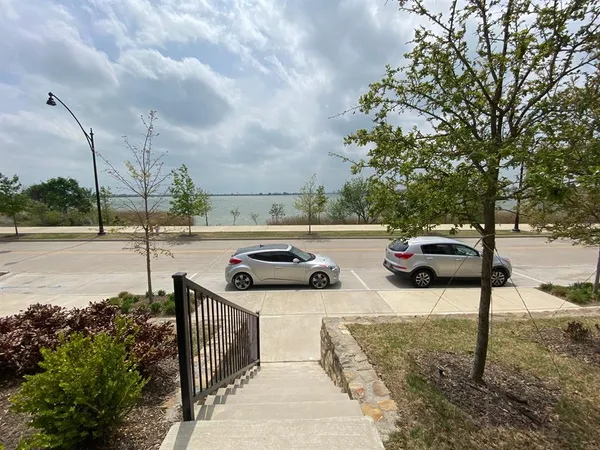 a view of a street with cars parked