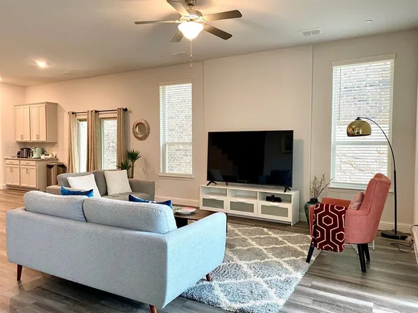 a living room with furniture and a flat screen tv