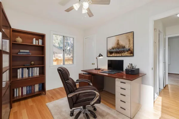 a view of a workspace with a bookshelf