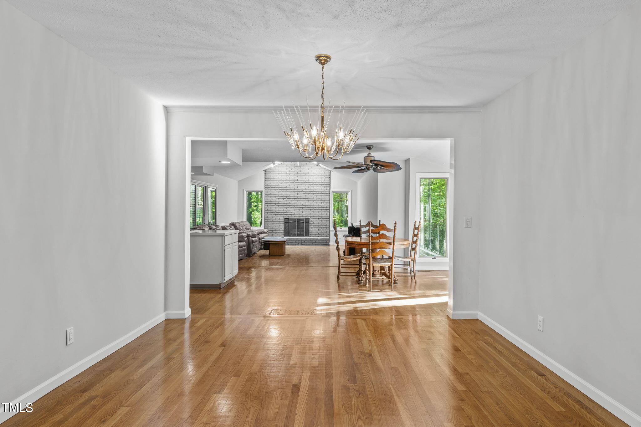 404 King George Loop Cary, NC 27511 - Photo 15 of 60 a view of a room with wooden floor potted plants and a chandelier