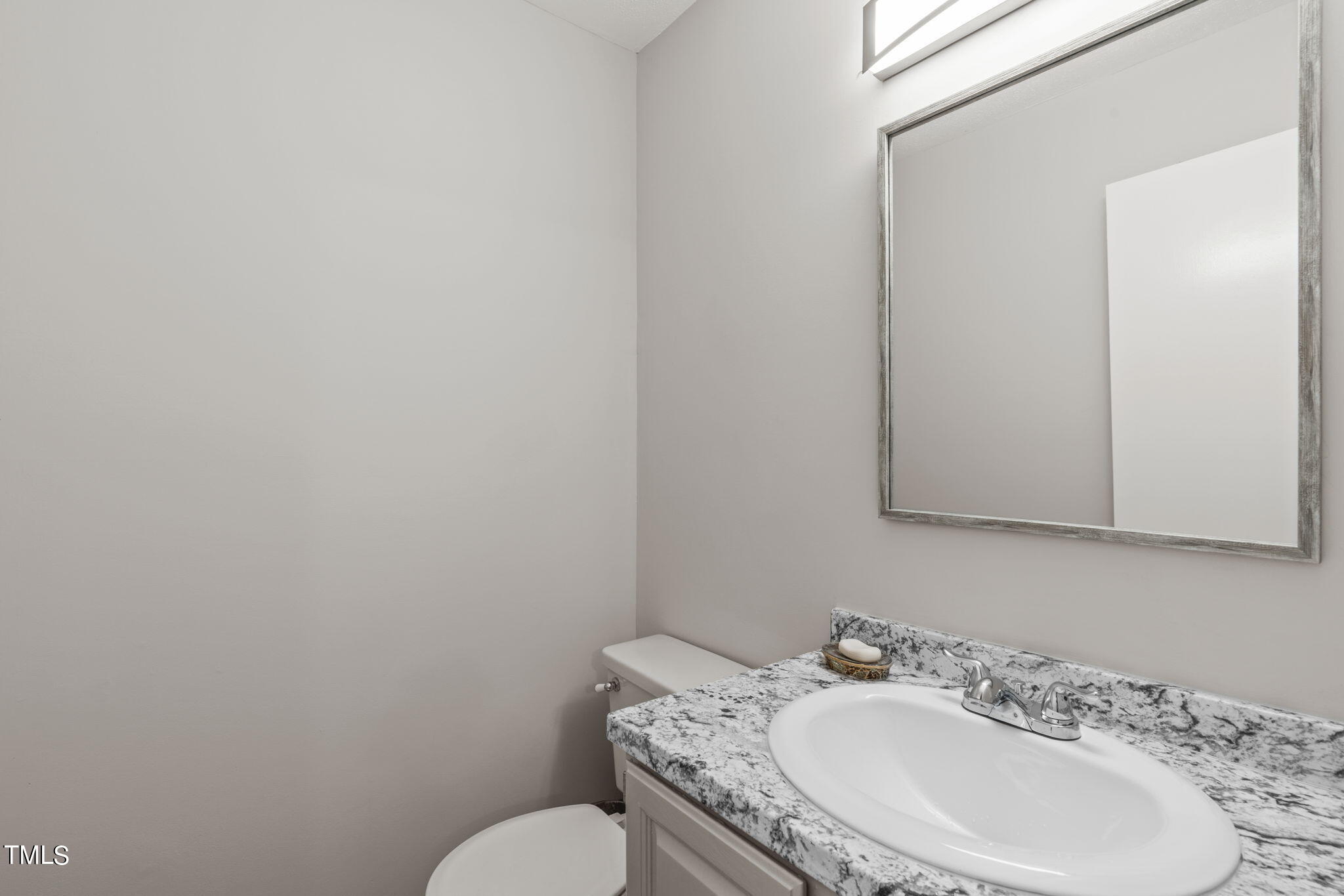 404 King George Loop Cary, NC 27511 - Photo 18 of 60 a bathroom with a granite countertop sink and a mirror