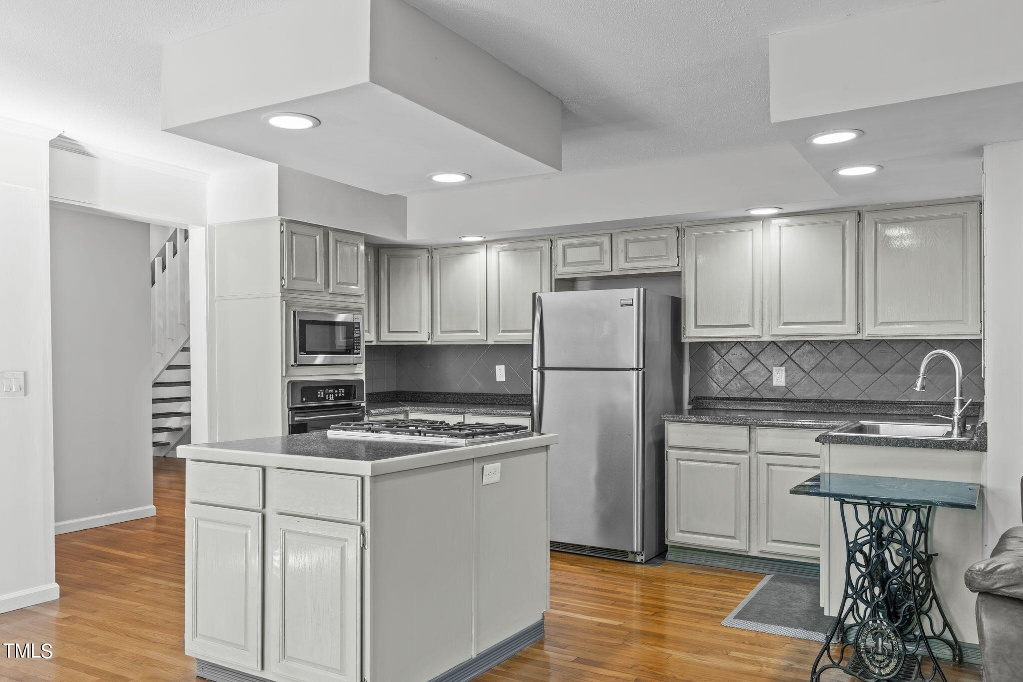 404 King George Loop Cary, NC 27511 - Photo 22 of 60 a kitchen with stainless steel appliances a refrigerator stove and sink