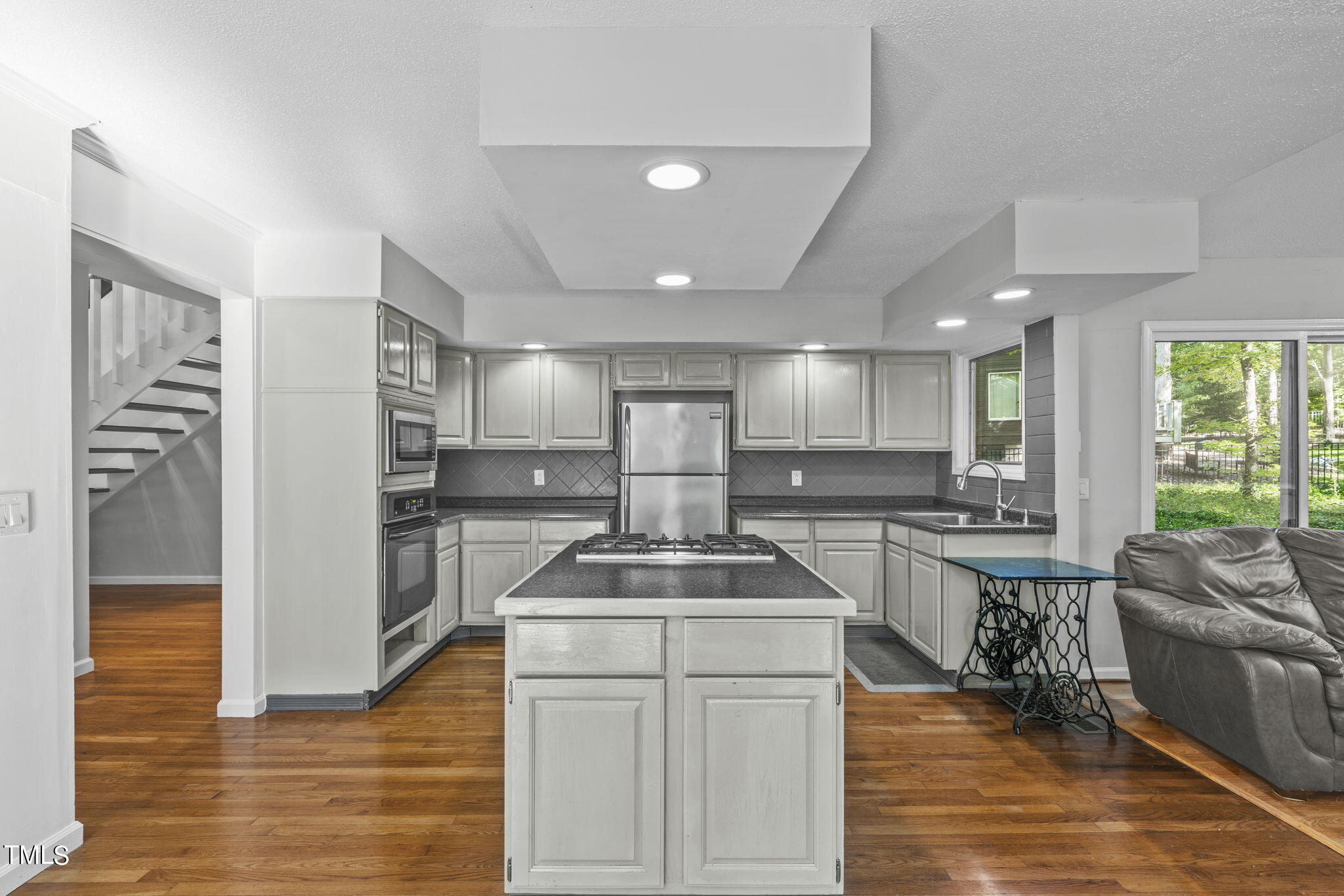 404 King George Loop Cary, NC 27511 - Photo 23 of 60 a kitchen that has a sink stainless steel appliances a counter space and a window
