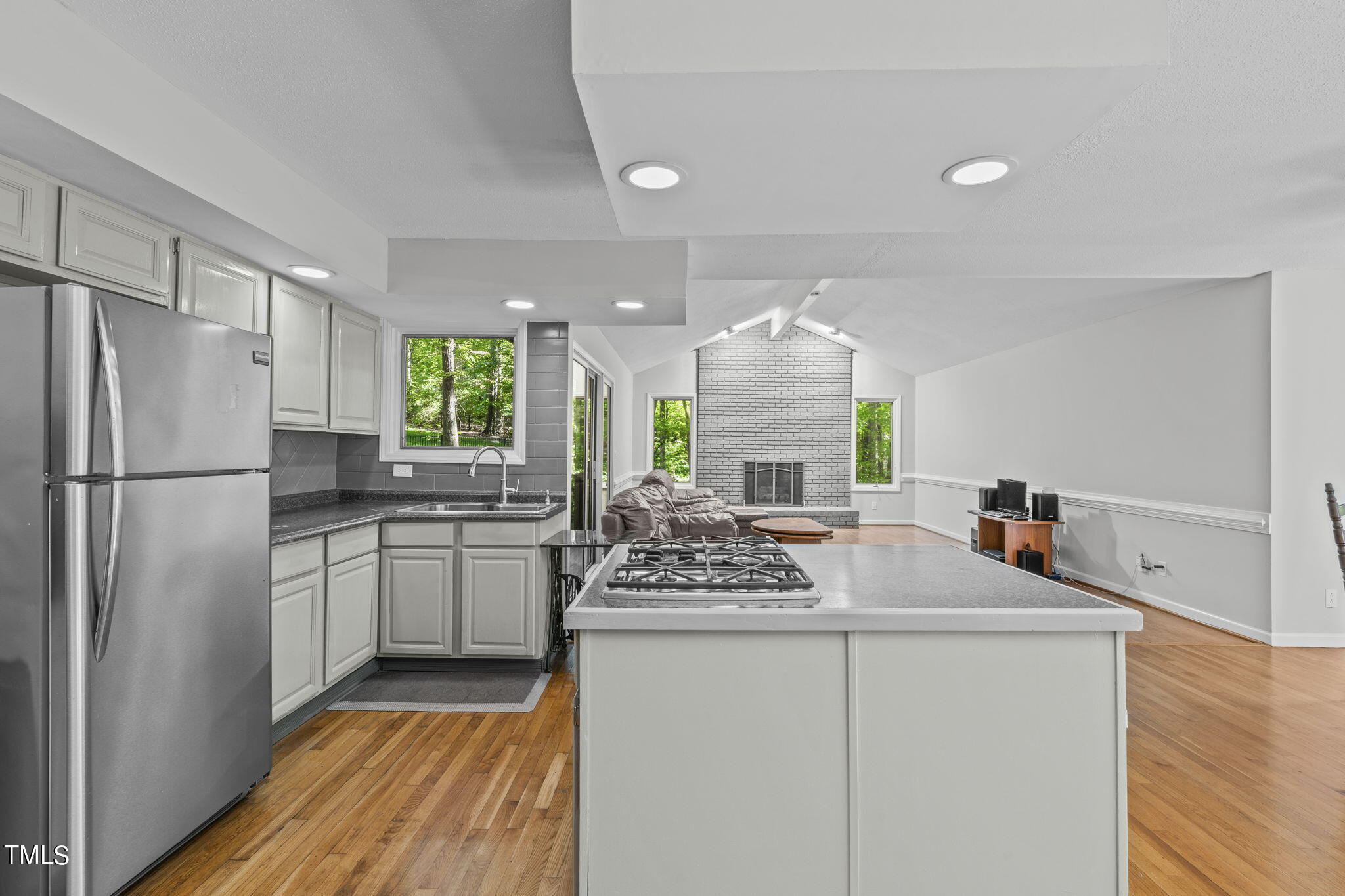 404 King George Loop Cary, NC 27511 - Photo 25 of 60 a kitchen with kitchen island a counter top space a sink stainless steel appliances and cabinets