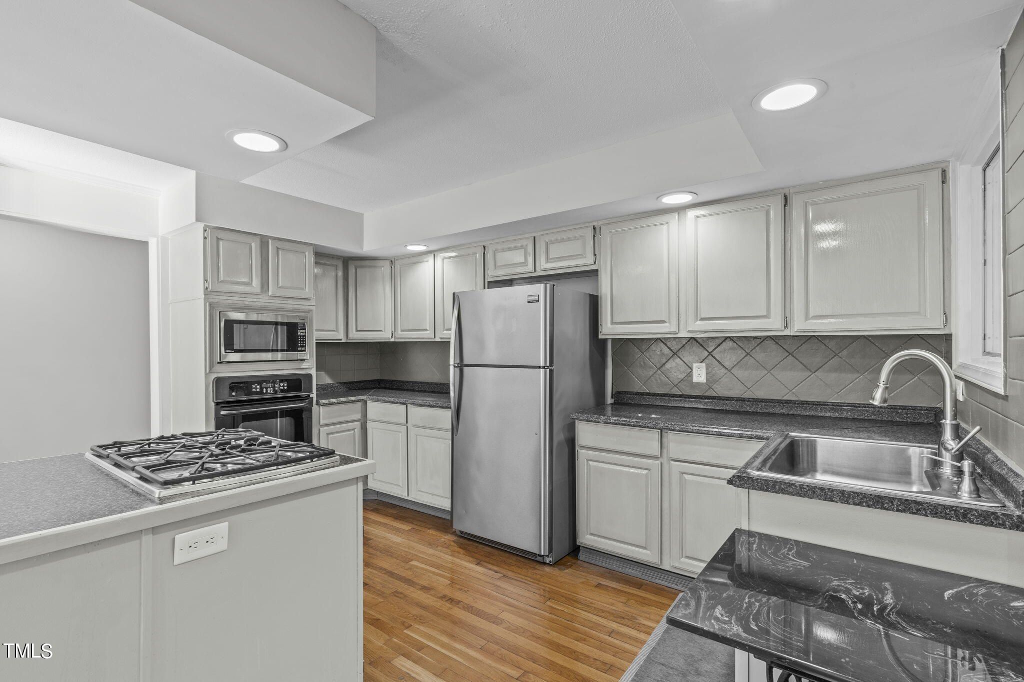 404 King George Loop Cary, NC 27511 - Photo 26 of 60 a kitchen with a refrigerator stove and sink