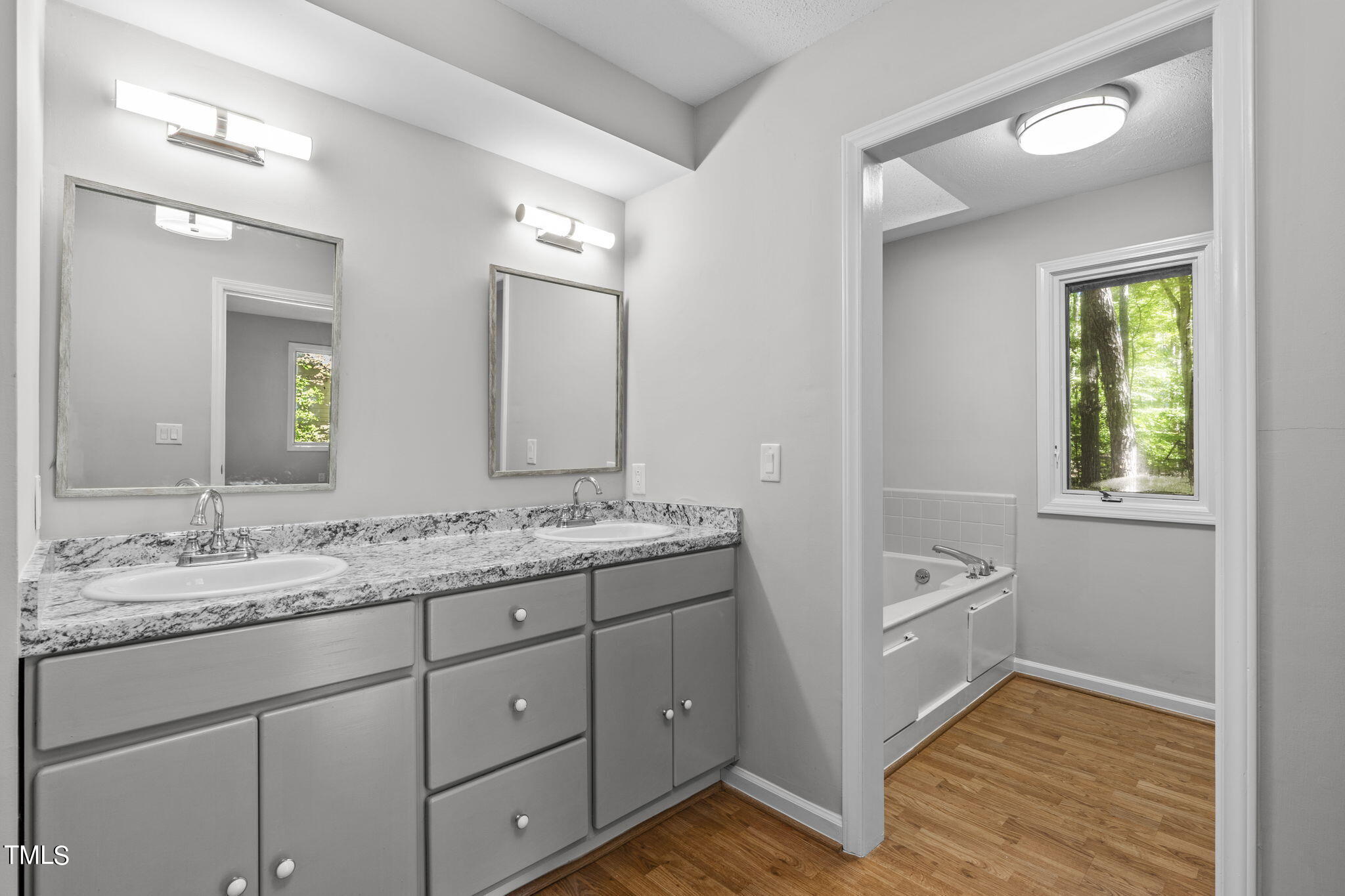 404 King George Loop Cary, NC 27511 - Photo 44 of 60 a en suite bathroom with a granite countertop sink and a mirror