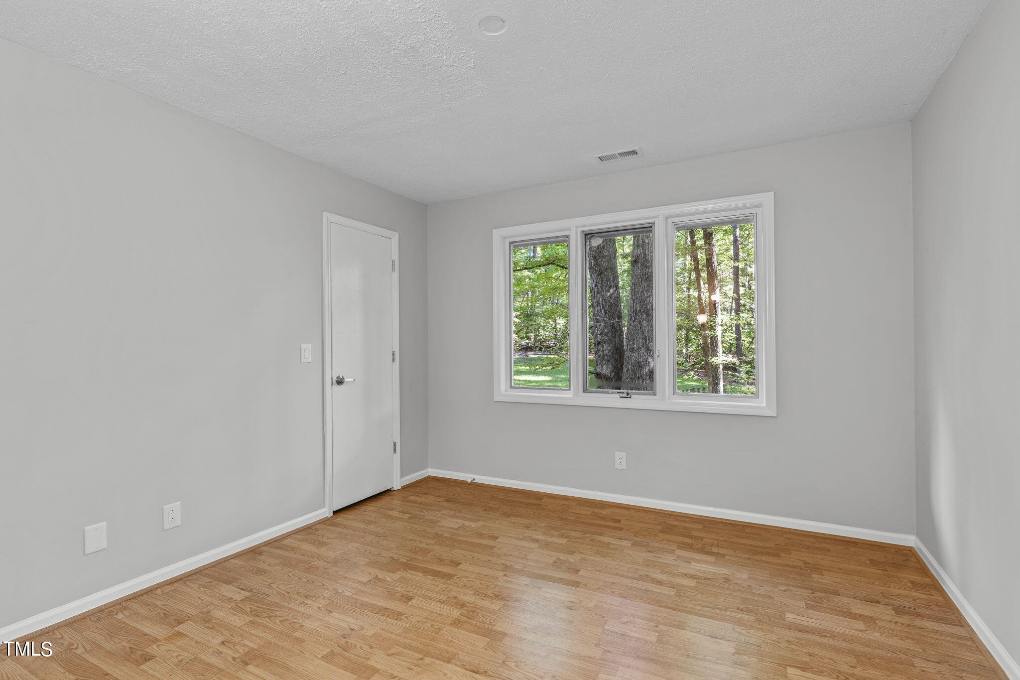 404 King George Loop Cary, NC 27511 - Photo 47 of 60 an empty room with wooden floor and windows