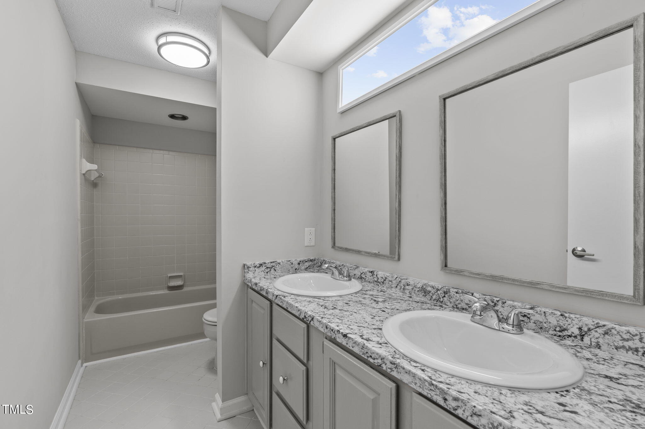 404 King George Loop Cary, NC 27511 - Photo 49 of 60 a bathroom with a granite countertop sink and a mirror a bathtub