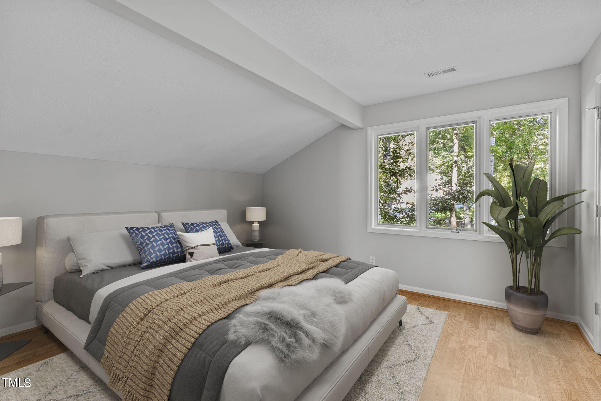 404 King George Loop Cary, NC 27511 - Photo 50 of 60 a bedroom with a large bed and a potted plant