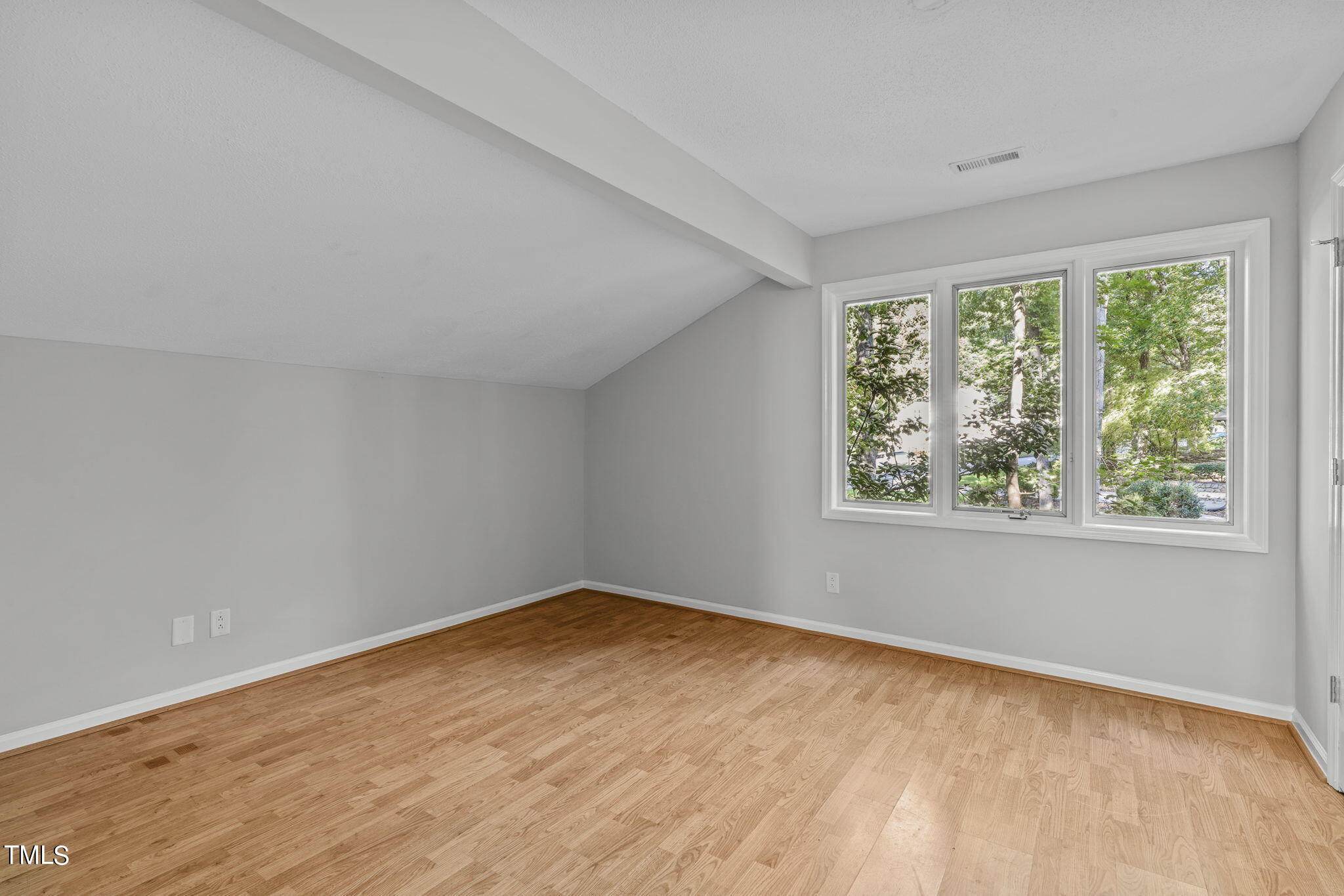404 King George Loop Cary, NC 27511 - Photo 51 of 60 a view of an empty room with wooden floor and a window