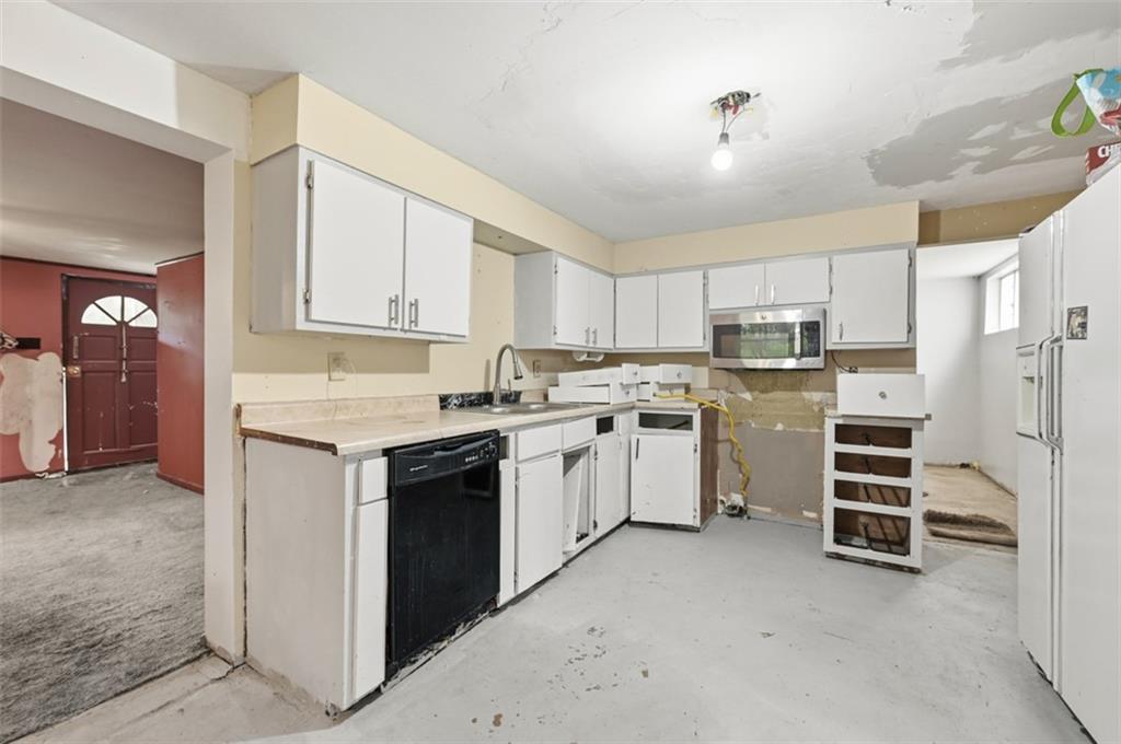 96 Meanor Street Imperial, PA 15126 - Photo 23 of 44 a kitchen with white cabinets and white appliances