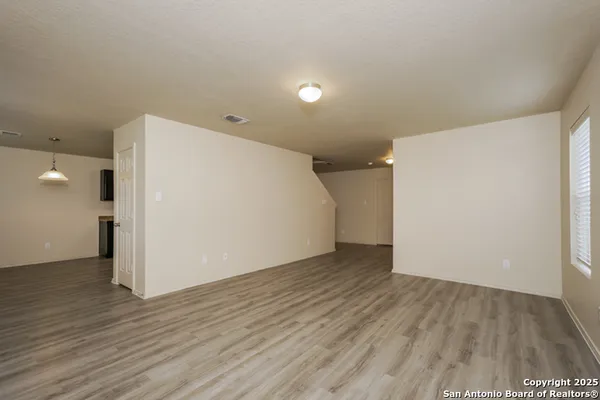 a view of a room with wooden floor