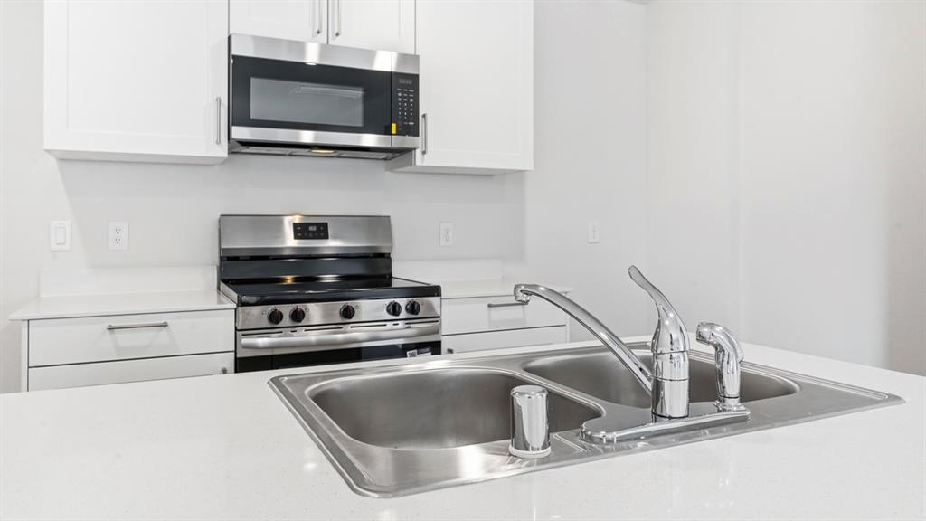 3519 Spring Time Street Forney, TX 75126 - Photo 24 of 37 Contemporary kitchen island featuring a double stainless steel sink with a chrome faucet
