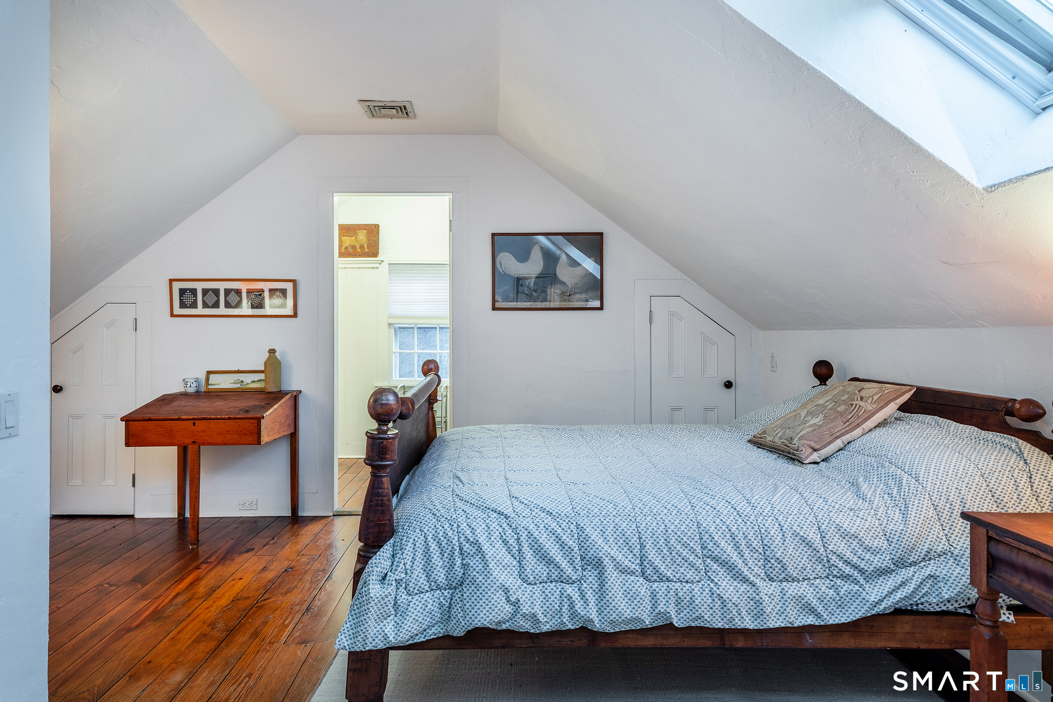 197 Skyline Ridge Road Bridgewater, CT 06752 - Photo 27 of 31 a bedroom with a bed and a lamp