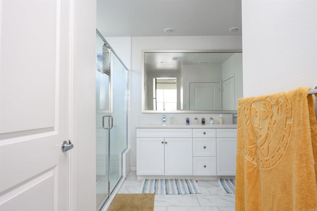 2040 Bravo Loop, Unit 5 Chula Vista, CA 91915 - Photo 20 of 58 a spacious bathroom with a mirror a shower and a sink