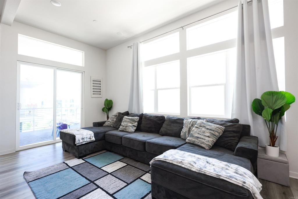 2040 Bravo Loop, Unit 5 Chula Vista, CA 91915 - Photo 37 of 58 a living room with furniture and a large window