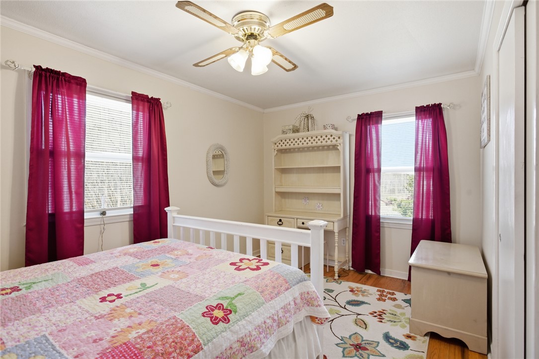 108 Hodge Street Abbeville, SC 29620 - Photo 18 of 39 Hardwood floors and a ceiling fan create a comfortable atmosphere in this well-lit bedroom.