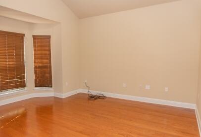 509 Pheasant Trail Crestview, FL 32536 - Photo 11 of 29 a view of an empty room with wooden floor and a window