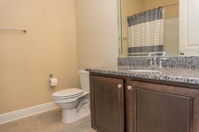 509 Pheasant Trail Crestview, FL 32536 - Photo 14 of 29 a bathroom with a granite countertop sink a toilet and a mirror