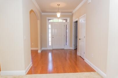 509 Pheasant Trail Crestview, FL 32536 - Photo 2 of 29 a view of an empty room with window and wooden floor