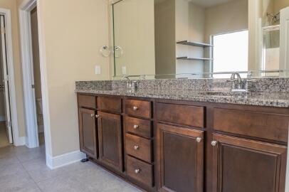509 Pheasant Trail Crestview, FL 32536 - Photo 24 of 29 a bathroom with a granite countertop sink and a mirror