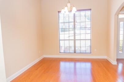 509 Pheasant Trail Crestview, FL 32536 - Photo 3 of 29 an empty room with wooden floor and windows