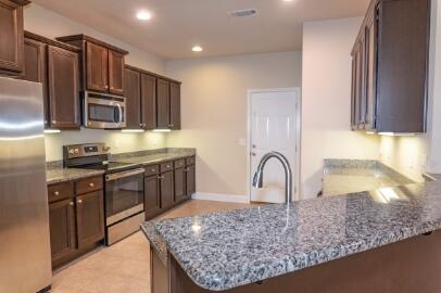 509 Pheasant Trail Crestview, FL 32536 - Photo 8 of 29 a kitchen with stainless steel appliances granite countertop a sink a stove and a refrigerator