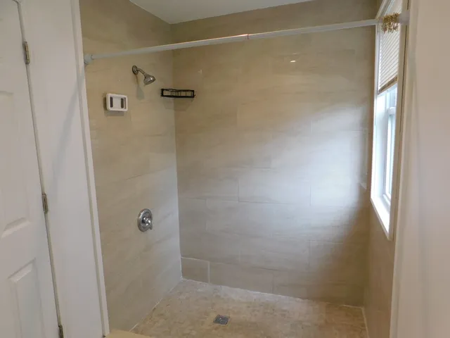 a bathroom with a glass shower door