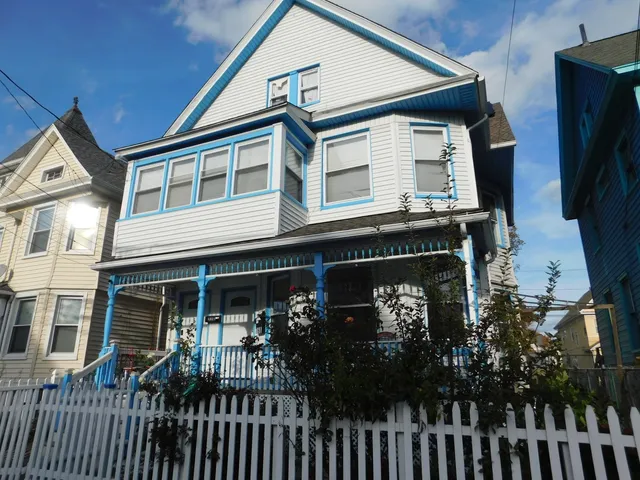 a front view of a house with plants