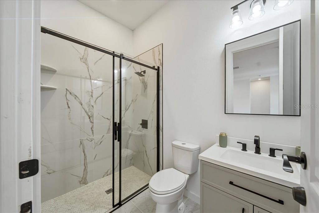 1215 Rio De Janeiro Avenue Punta Gorda, FL 33983 - Photo 56 of 65 a bathroom with a sink vanity mirror and toilet