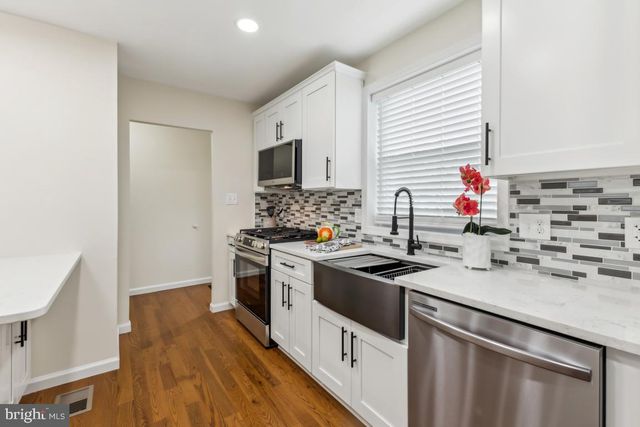 a kitchen that has a sink and a stove