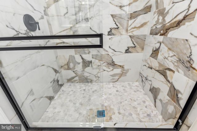 a white bath tub sitting in a bathroom