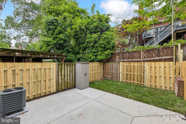 a view of a entrance gate of a house with a fence