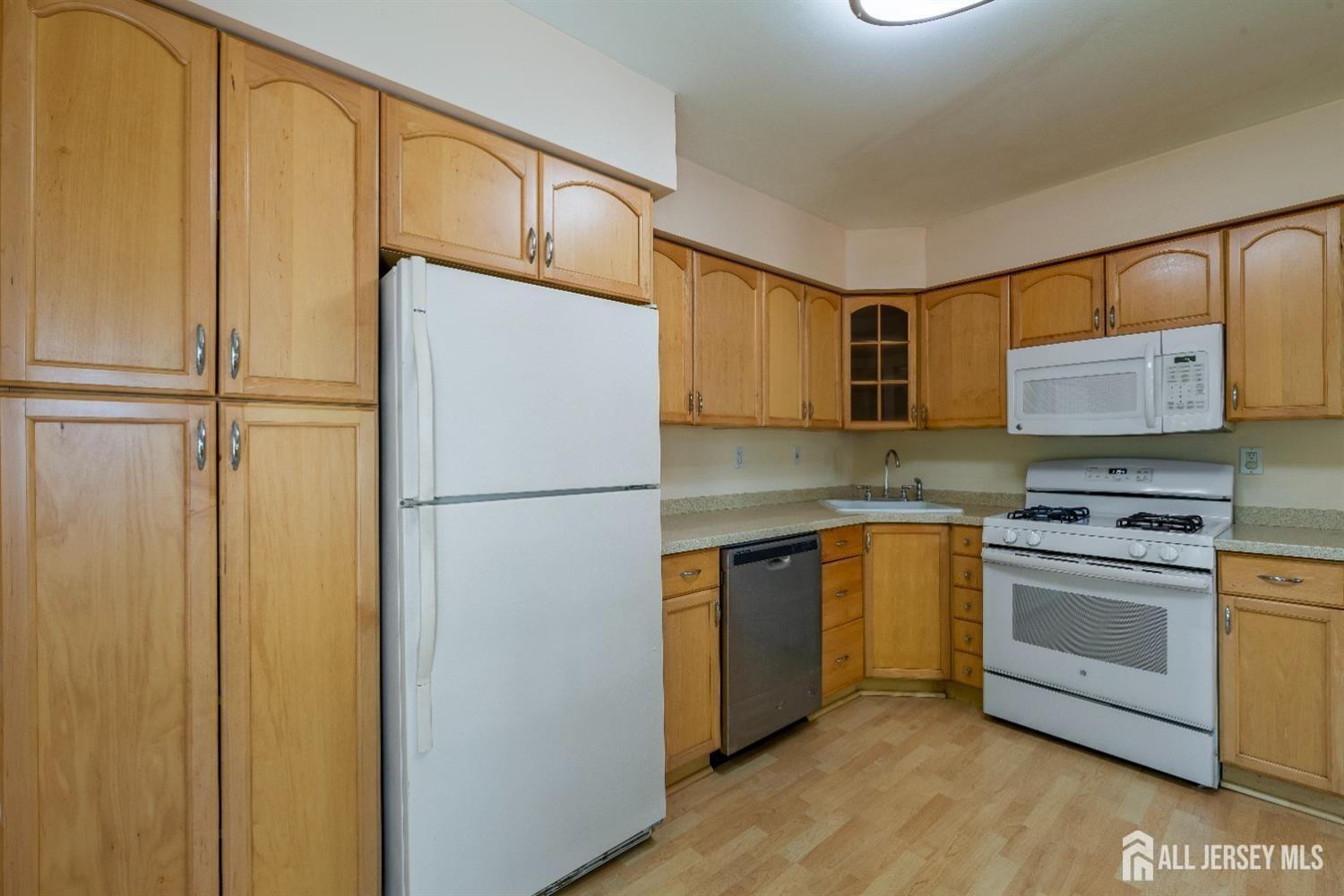 201 Maplecrest Road Edison, NJ 08820 - Photo 10 of 33 a kitchen with stainless steel appliances a refrigerator and a stove top oven