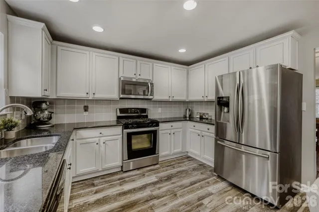 a kitchen with a refrigerator stove and sink