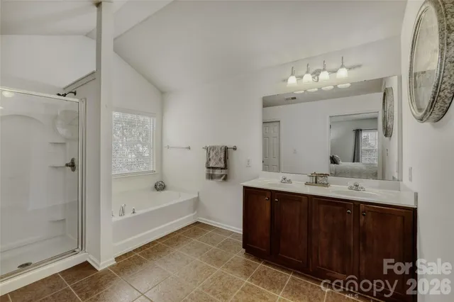 a bathroom with a tub sink and mirror