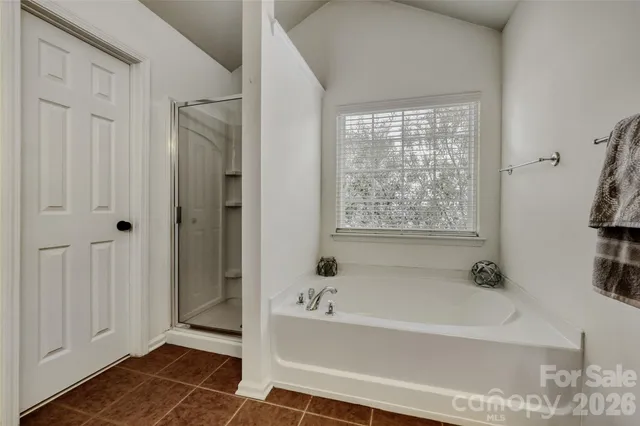 a bathroom with a bathtub and shower