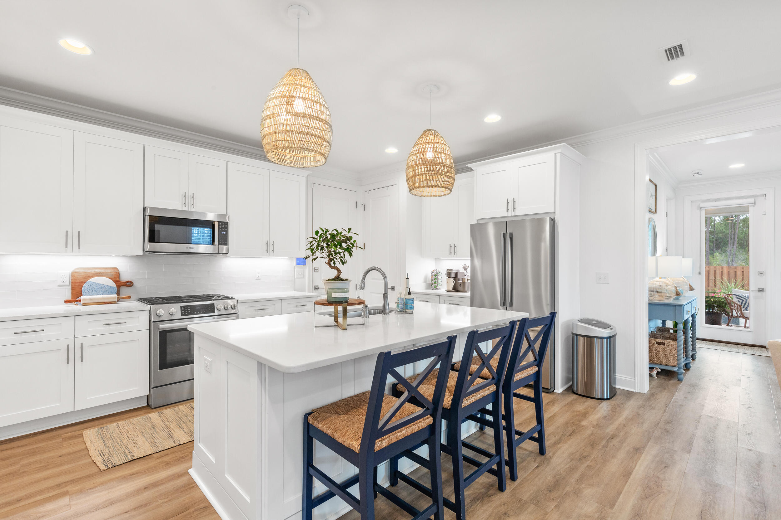 229 Windrow Way Inlet Beach Inlet Beach, FL 32461 - Photo 6 of 43 a kitchen with stainless steel appliances granite countertop a kitchen island hardwood floor sink stove dining table and chairs