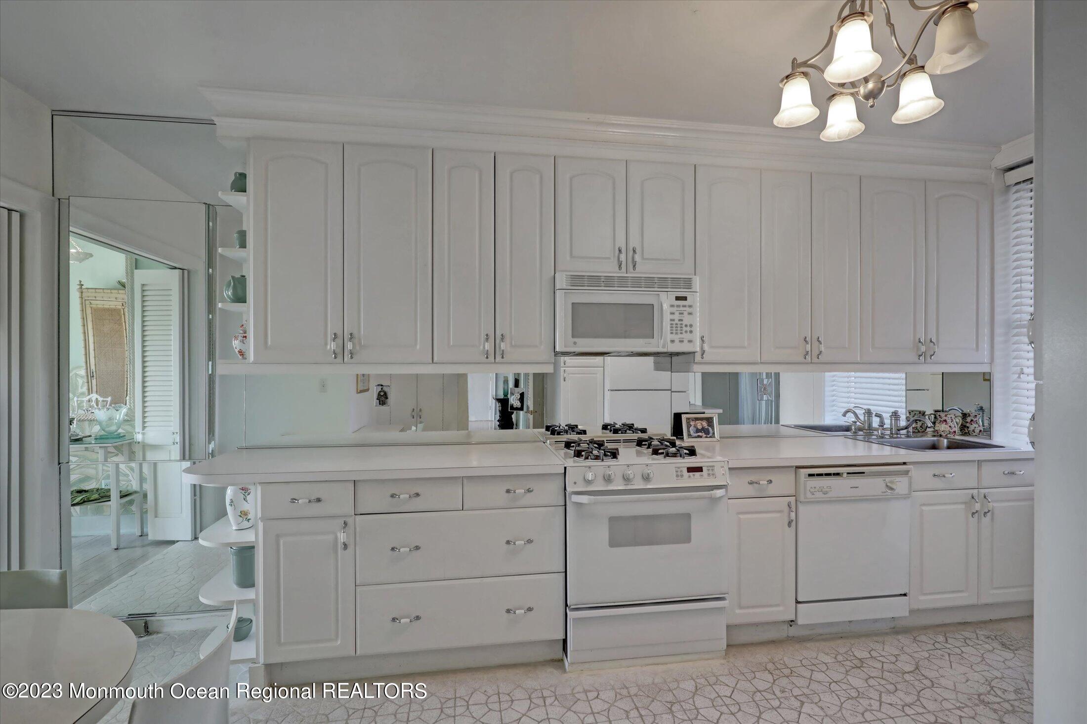 1 Roseld Avenue, Unit A3 Deal, NJ 07723 - Photo 12 of 35 a kitchen with cabinets appliances a sink and a counter top space