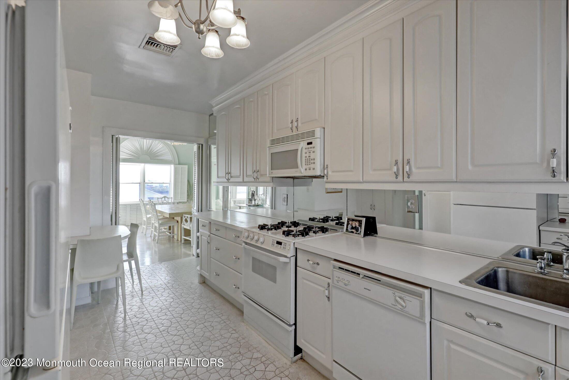 1 Roseld Avenue, Unit A3 Deal, NJ 07723 - Photo 13 of 35 a kitchen with cabinets a sink and appliances