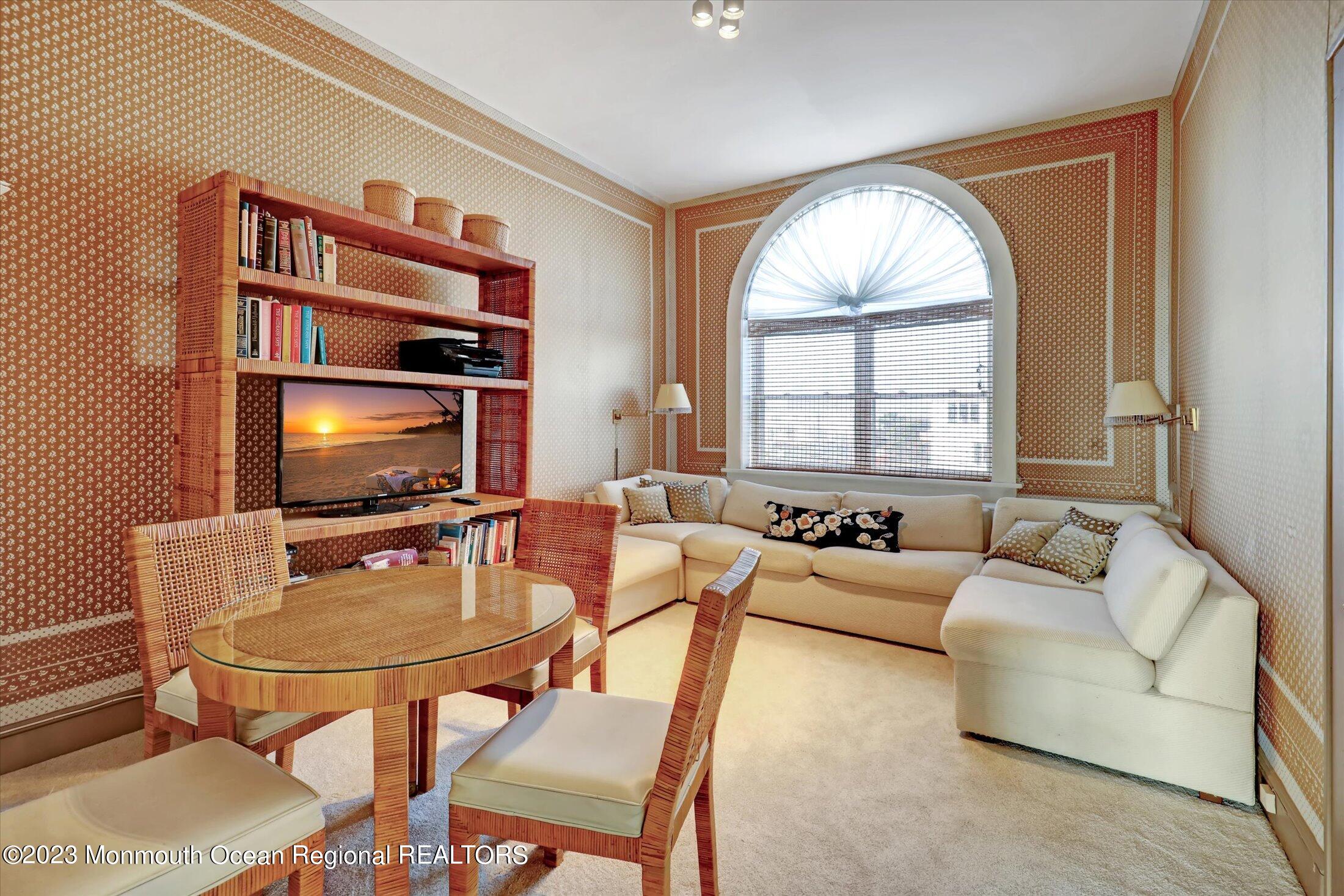 1 Roseld Avenue, Unit A3 Deal, NJ 07723 - Photo 15 of 35 a living room with furniture a flat screen tv and a window