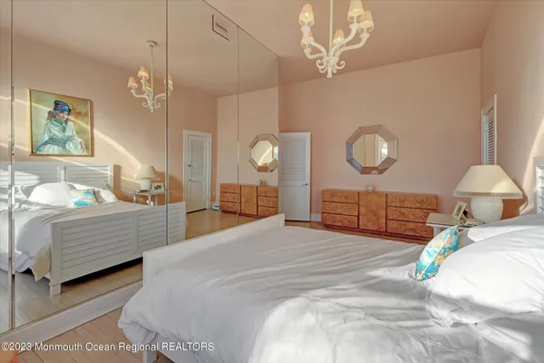 a bedroom with a bed and a chandelier